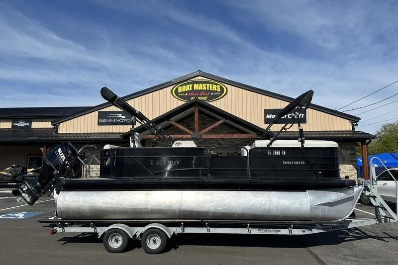 Slide: The Image of 2022 Godfrey Sweetwater 2186 C4 pontoon boat on trailer outside dealership. - 17