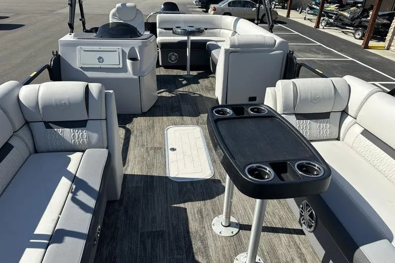 Slide: The Image of 2022 Godfrey Sweetwater 2186 C4 pontoon boat interior with seating and table. - 2