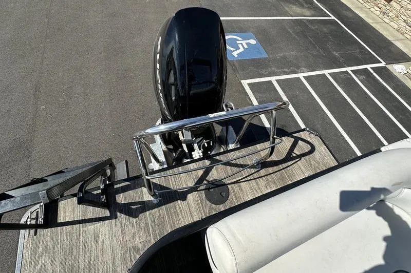 Slide: The Image of 2022 Godfrey Sweetwater 2186 C4 boat with outboard motor in parking area. - 23