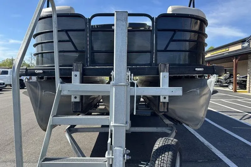 Slide: The Image of 2022 Godfrey Sweetwater 2186 C4 pontoon boat on trailer, parked outdoors. - 5