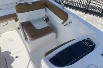 Slide: The Image of 2022 Bayliner VR6 Bowrider OB interior with seating and cup holder. - 11