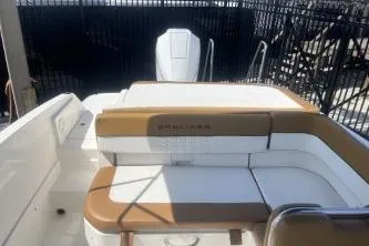 Slide: The Image of 2022 Bayliner VR6 Bowrider OB boat interior with tan and white seating. - 12