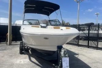 Slide: The Image of 2022 Bayliner VR6 Bowrider OB boat on trailer, displayed outdoors under clear sky. - 3