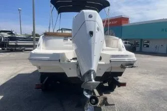 Slide: The Image of 2022 Bayliner VR6 Bowrider OB with outboard motor, parked outdoors on a sunny day. - 6