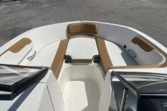Slide: The Image of 2022 Bayliner VR6 Bowrider OB boat interior with tan and white seating. - 9
