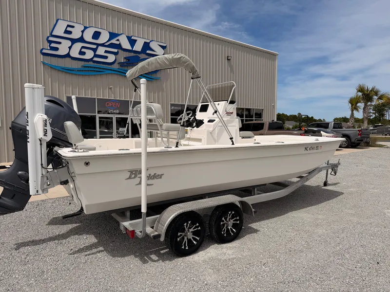 Slide: The Image of 2022 KenCraft Bay Rider 2060 in front of a boat dealership. - 1