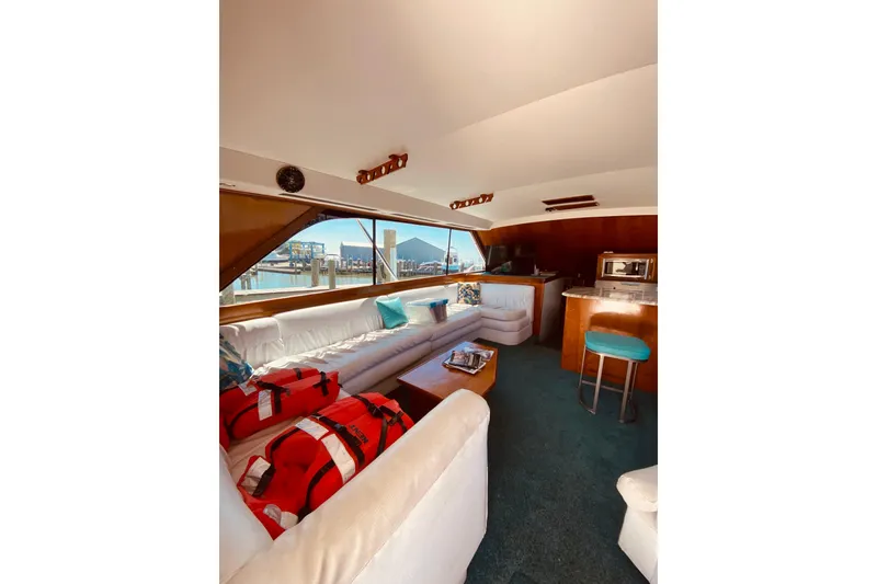 Slide: The Image of U-shaped white seating and marina view. - 13