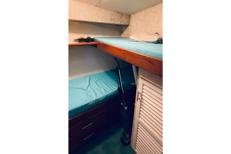 Slide: The Image of Starboard side cabin of 1986 Ocean Yachts 48 Super Sport with bunk beds and storage. - 15