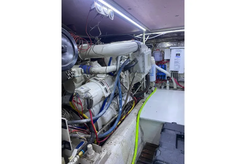 Slide: The Image of Engine room of 1986 Ocean Yachts 48 Super Sport with visible wiring and components. - 19