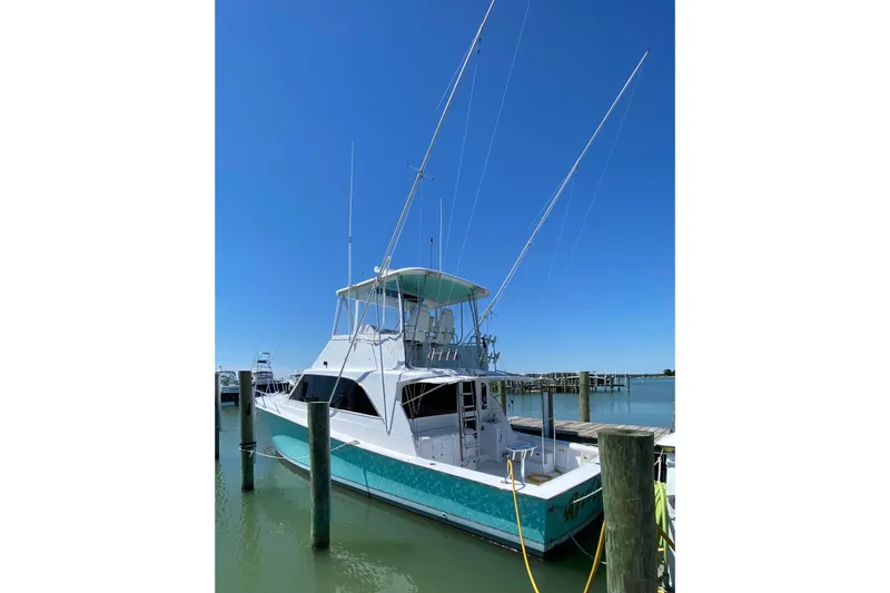 Slide: The Image of 1986 Ocean Yachts 48 Super Sport docked under clear blue sky. - 2