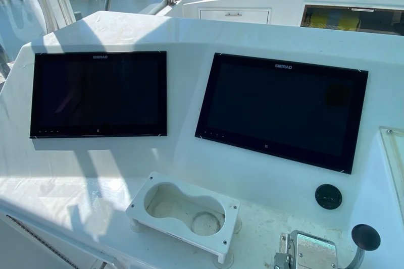 Slide: The Image of Control panel of 1986 Ocean Yachts 48 Super Sport with dual Simrad displays. - 24