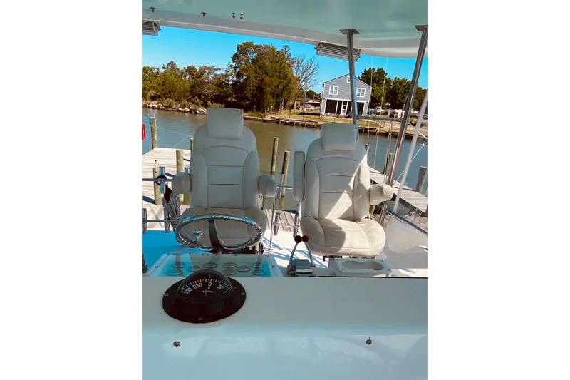 Slide: The Image of 1986 Ocean Yachts 48 Super Sport helm with dual captain chairs, dockside view. - 27