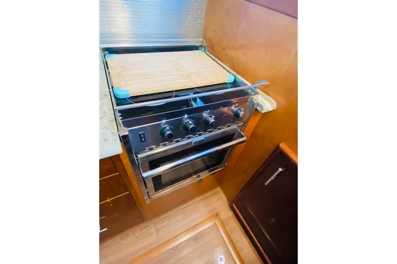 Slide: The Image of Stainless steel stove and oven in 1986 Ocean Yachts 48 Super Sport kitchen. - 9