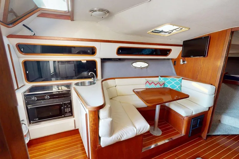Slide: The Image of Interior of a 1989 Tiara 3300 Open yacht with cozy seating and modern amenities. - 10