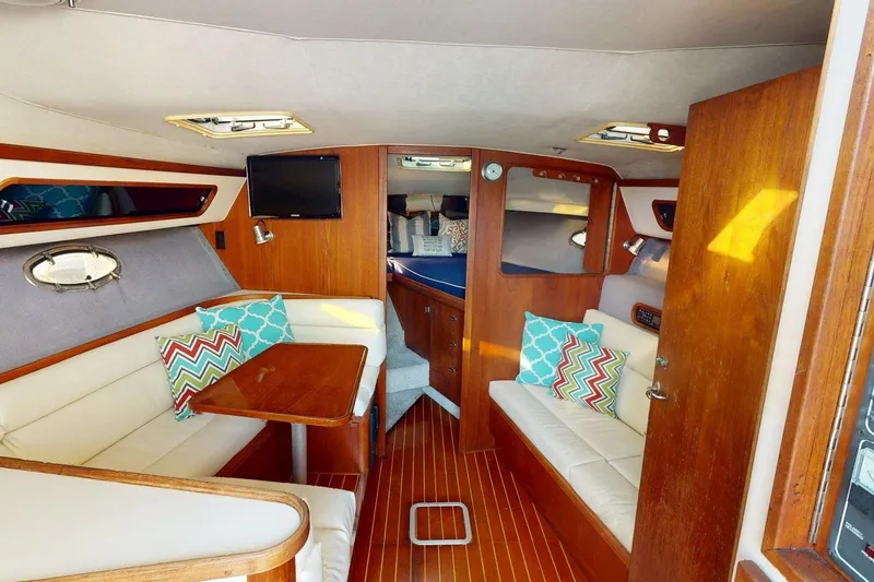 Slide: The Image of Interior of a 1989 Tiara 3300 Open yacht with cozy seating and vibrant cushions. - 11