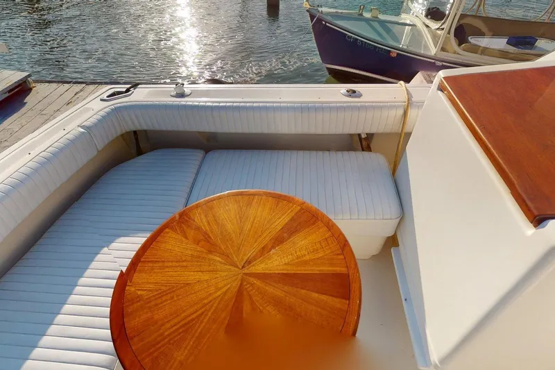 Slide: The Image of 1989 Tiara 3300 Open boat interior with white seating and wooden table. - 14