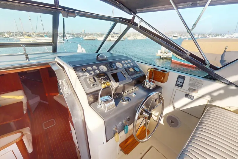 Slide: The Image of Cockpit of 1989 Tiara 3300 Open yacht with steering wheel and control panel. - 19