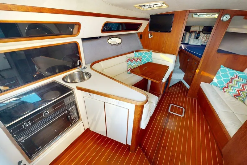 Slide: The Image of Interior of a 1989 Tiara 3300 Open yacht with cozy seating and modern amenities. - 2