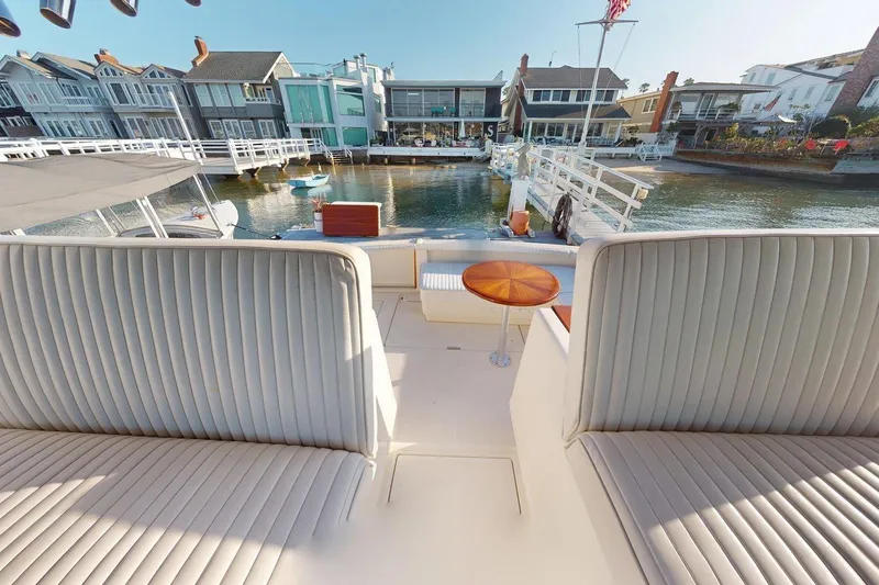 Slide: The Image of 1989 Tiara 3300 Open yacht interior with waterfront view and luxurious seating. - 21