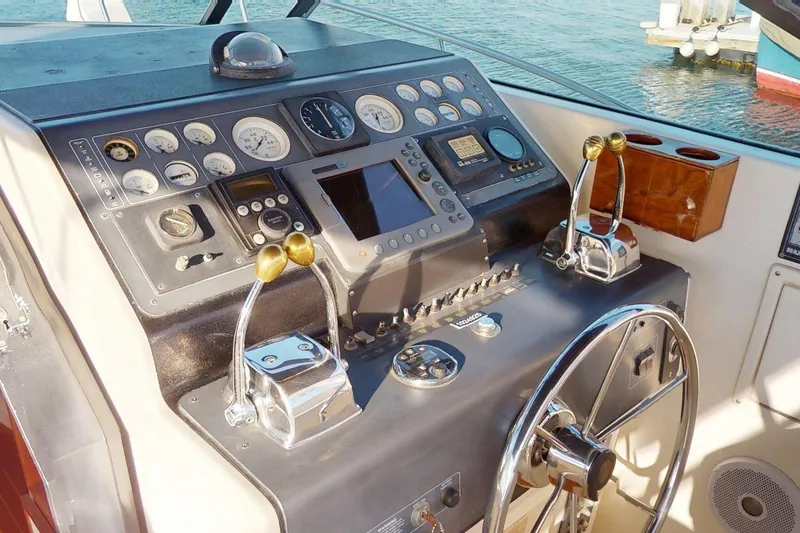 Slide: The Image of Control panel of a 1989 Tiara 3300 Open boat with steering wheel and gauges. - 22