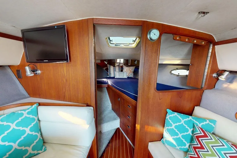 Slide: The Image of Interior of a 1989 Tiara 3300 Open yacht with cozy seating and wood paneling. - 23