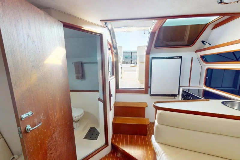 Slide: The Image of Interior of 1989 Tiara 3300 Open yacht with wooden finishes and compact amenities. - 24