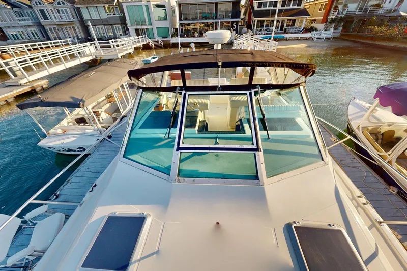 Slide: The Image of 1989 Tiara 3300 Open yacht docked at marina, showcasing spacious deck and sleek design. - 26