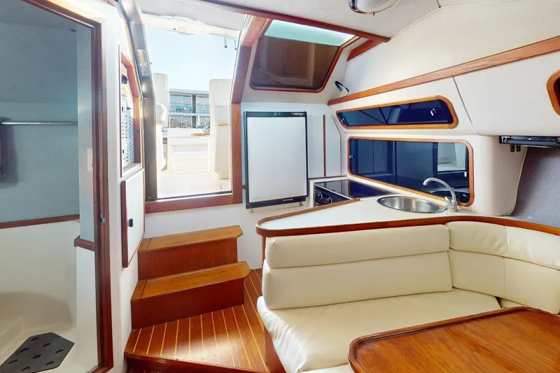 Slide: The Image of Interior of a 1989 Tiara 3300 Open yacht with kitchen and seating area. - 29