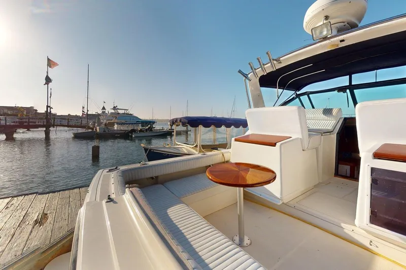 Slide: The Image of 1989 Tiara 3300 Open yacht docked at marina, featuring spacious seating and elegant design. - 31