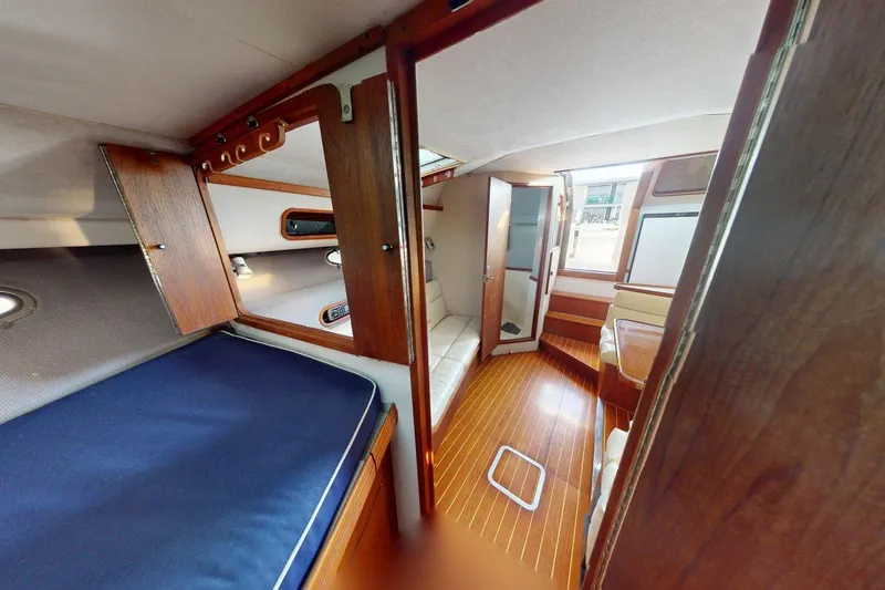 Slide: The Image of 1989 Tiara 3300 Open cabin interior with wood accents and cozy seating area. - 7