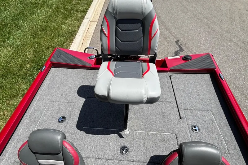Slide: The Image of 2024 Ranger RT188 boat interior with gray and red seating on a sunny day. - 13