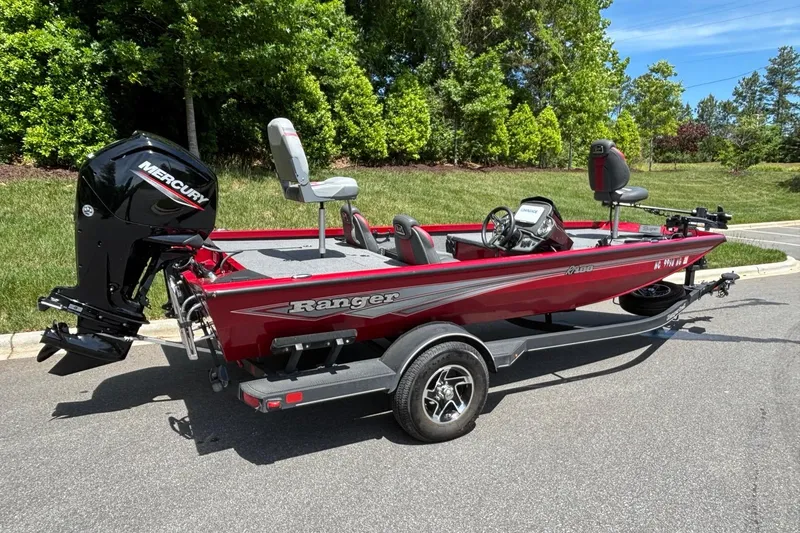 Slide: The Image of 2024 Ranger RT188 boat with Mercury engine on trailer, parked outdoors. - 15