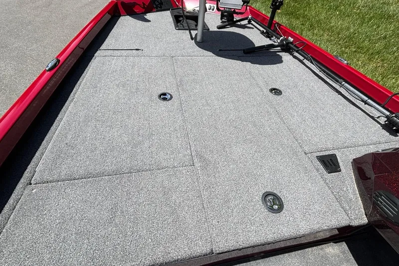 Slide: The Image of 2024 Ranger RT188 boat deck with gray carpet and red trim, featuring storage compartments. - 9