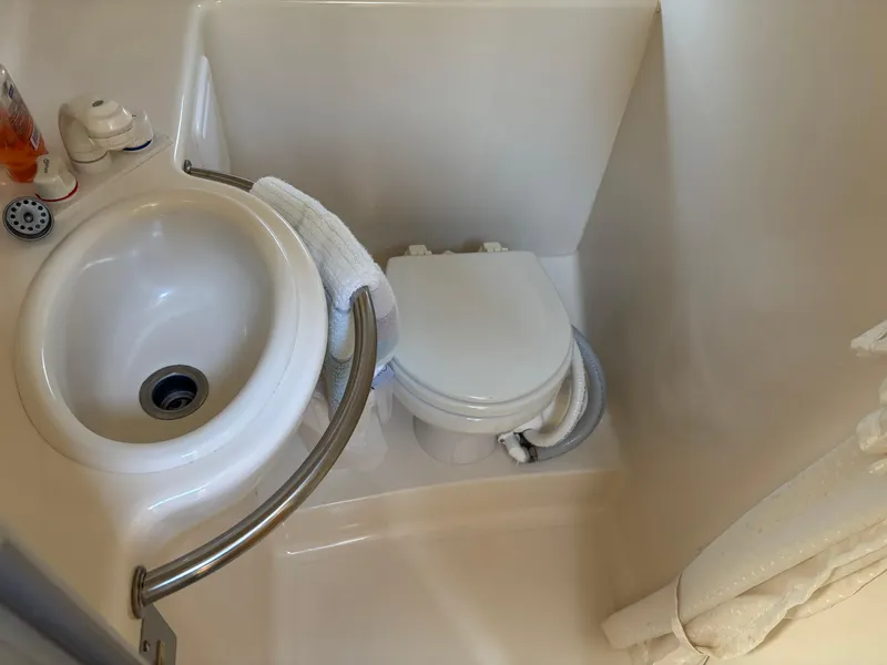Slide: The Image of Compact bathroom in 2004 Maxum 2900 SCR boat with sink and toilet. - 20
