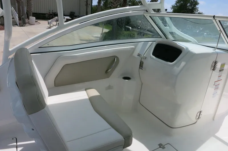 Slide: The Image of 2018 Robalo R247 Dual Console boat interior with seating and console. - 13