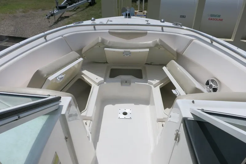 Slide: The Image of 2018 Robalo R247 Dual Console boat interior with seating and storage compartments. - 17