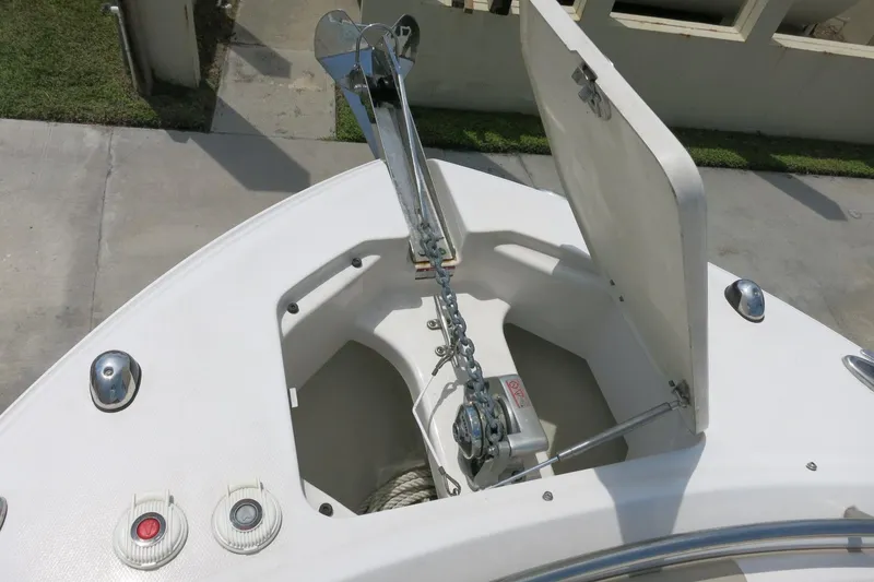 Slide: The Image of Anchor compartment of 2018 Robalo R247 Dual Console boat, featuring winch and controls. - 18