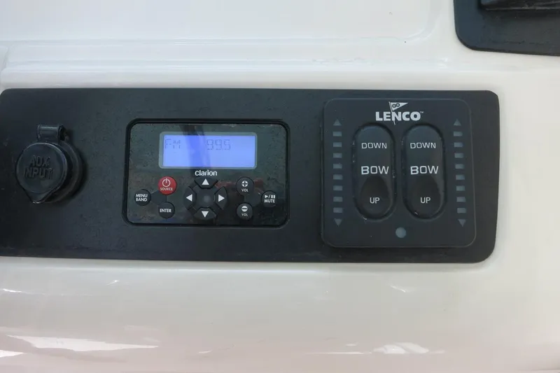 Slide: The Image of Control panel of a 2018 Robalo R247 Dual Console boat with Clarion audio and Lenco trim tabs. - 26