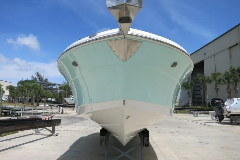 Slide: The Image of 2018 Robalo R247 Dual Console boat on trailer, marina background, clear sky. - 5