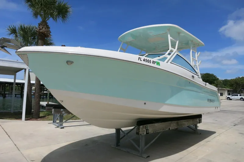 Slide: The Image of 2018 Robalo R247 Dual Console boat on display, light blue hull, sunny day. - 6