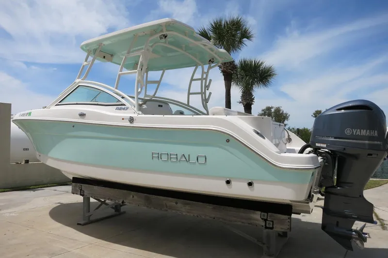 Slide: The Image of 2018 Robalo R247 Dual Console boat with Yamaha engine, parked outdoors. - 7