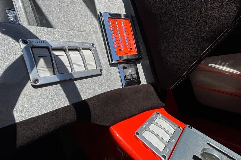 Slide: The Image of Interior controls of a 2020 Eliminator 36 Daytona Coupe boat, featuring switches and gauges. - 26