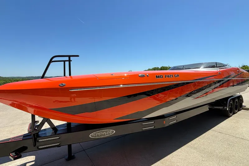 Slide: The Image of 2020 Eliminator 36 Daytona Coupe boat in vibrant orange on trailer. - 3