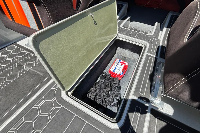 Slide: The Image of Open storage compartment in 2020 Eliminator 36 Daytona Coupe with first aid kit and rope. - 36