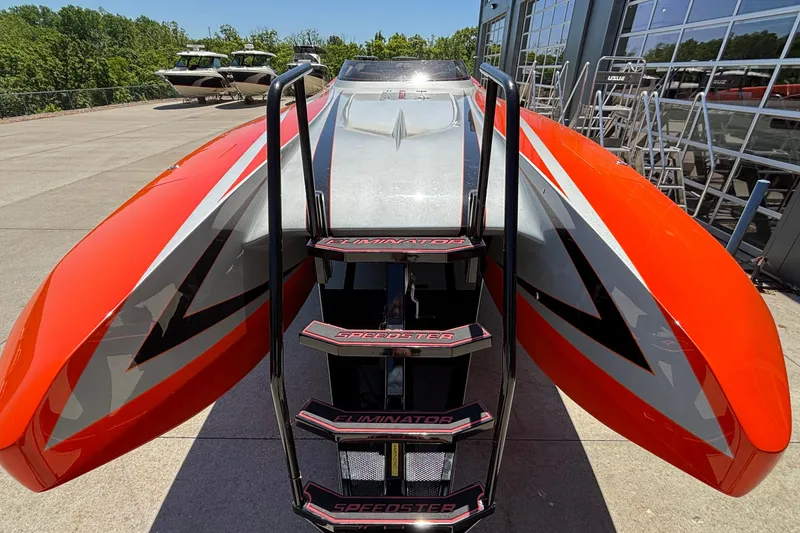 Slide: The Image of 2020 Eliminator 36 Daytona Coupe speedboat with vibrant orange and silver design, docked outdoors. - 4