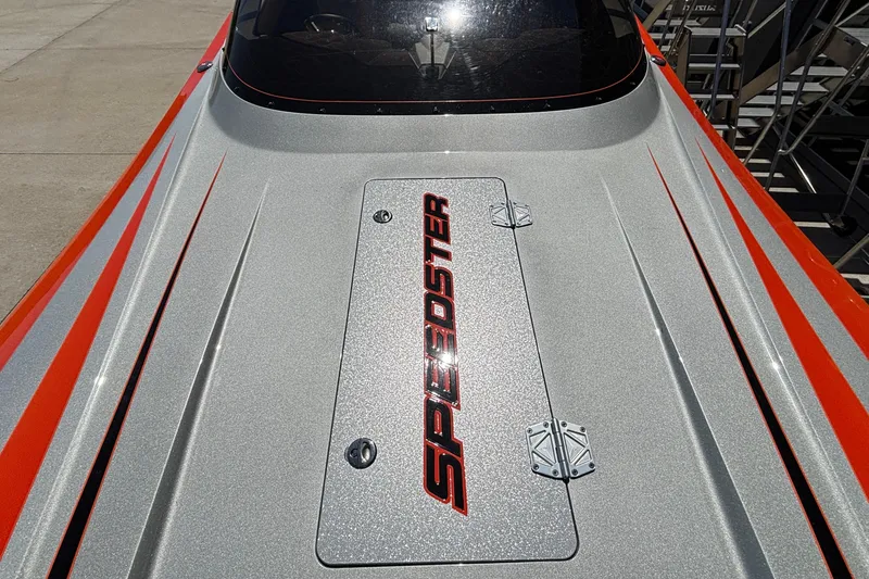 Slide: The Image of 2020 Eliminator 36 Daytona Coupe boat with sleek silver and orange design, "Speedster" branding. - 6