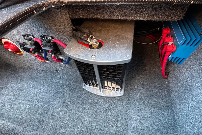 Slide: The Image of 2020 Eliminator 36 Daytona Coupe electrical components and wiring setup in carpeted compartment. - 61