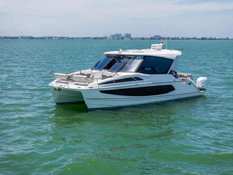 Slide: The Image of Aquila 36 Sport 2023 on calm waters near coastline. - 1