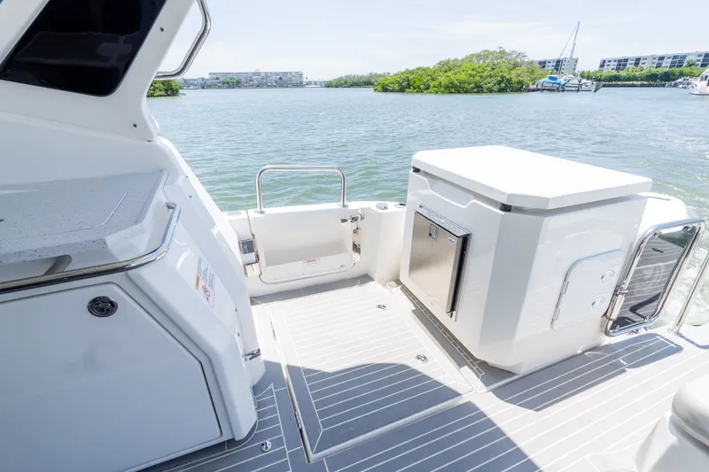 Slide: The Image of Aquila 36 Sport 2023 boat with modern deck design and water view. - 11