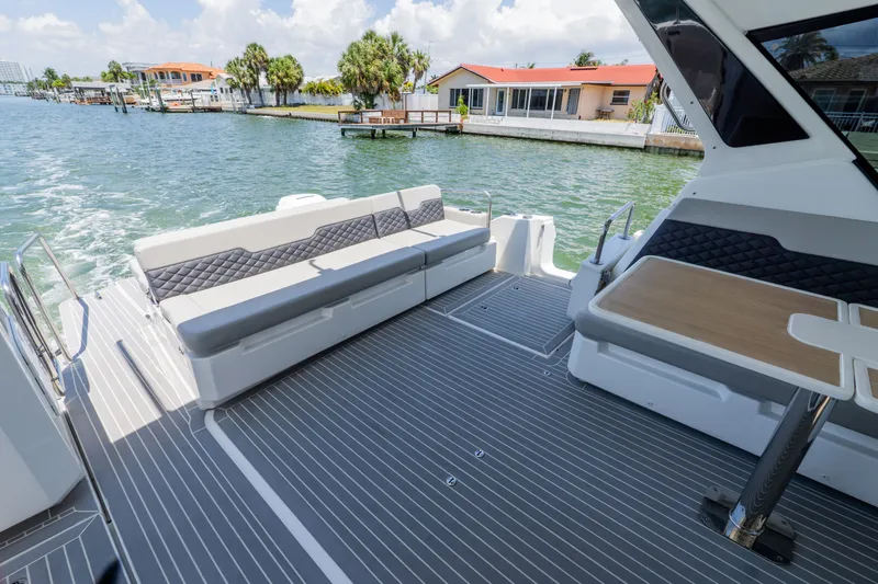 Slide: The Image of Aquila 36 Sport 2023 with stylish deck and seating area by the water. - 13